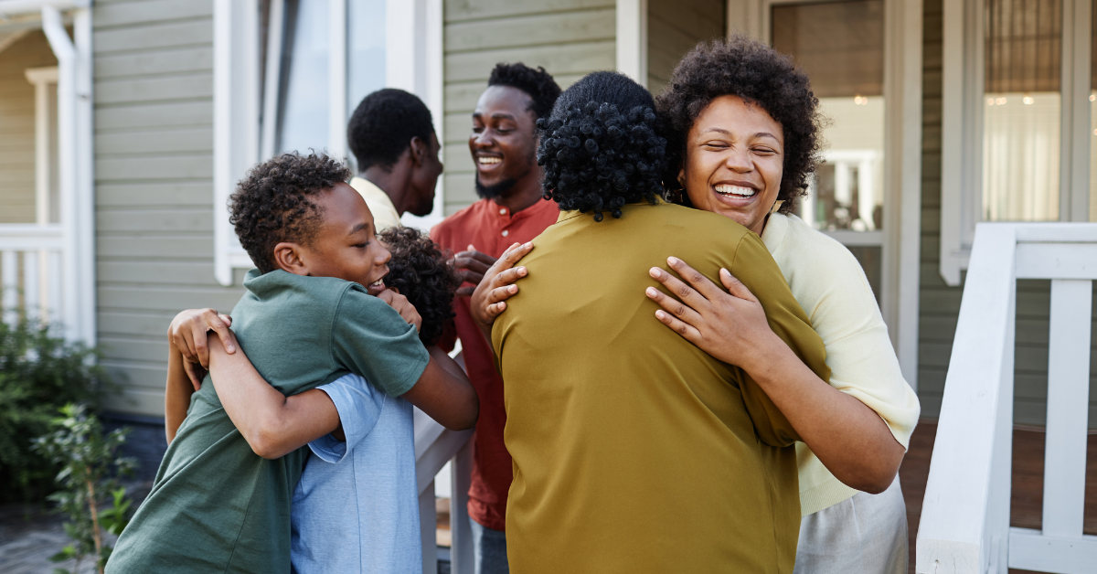 A family embracing on a sunny porch